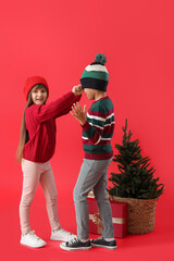 Sticker - Happy little children in winter clothes, with Christmas tree and gift on color background