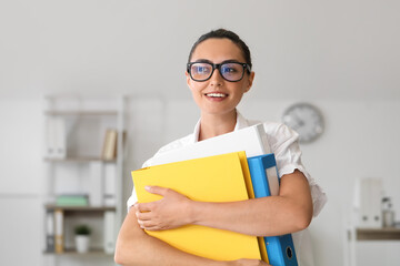 Canvas Print - Young woman working with documents in office