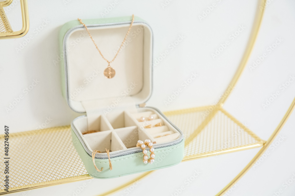 Jewelry box with stylish accessories on shelf