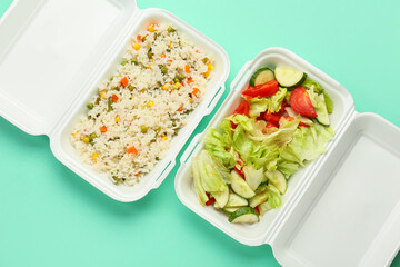 Rice with vegetables and salad mix in lunch boxes on color background