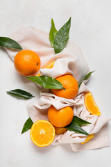 Wall Mural - Fresh juicy oranges with leaves on white background