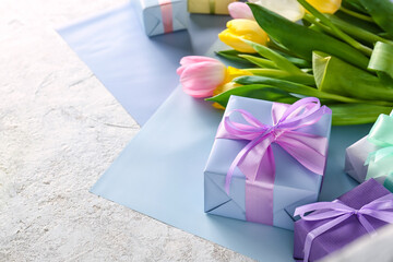 Wall Mural - Composition with gift boxes and flowers for International Women's Day celebration on light background, closeup