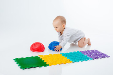 a baby boy with an orthopedic mat and a hemisphere is isolated on a white background