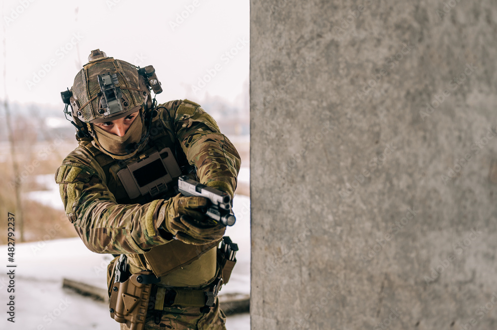 Special forces operator wearing Multicam uniform and his handgun xdm ...