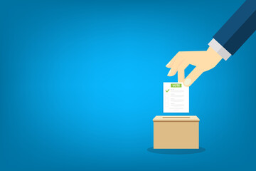 Hand holding voting ballot and ballot box. Voting and election concept. 