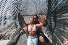 Two Pretty Mermaids Caught In A Fishing Net Under The Hot Sun On The Beach