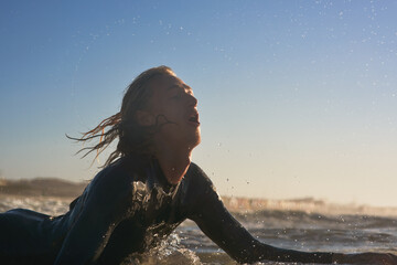 Sticker - He's caught up in the wave. Shot of a handsome young man surfing in the ocean.