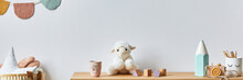 Stylish Scandinavian Newborn Baby Room With Toys, Plush Animal, Photo Camera, Doll And Child Accessories. Cozy Decoration And Hanging Cotton Balls On The White Wall. Copy Space.