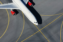 Aerial view of plane at airport. Airplane taxiing to runway before take off...