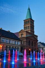 Wall Mural - Market square with a fountain and church bell tower in Międzyrzecz