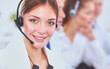 © lenets_tan - Businesswoman with headset smiling at camera in call center