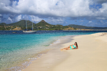 Wall Mural - Young woman in bikini relaxing at the beach, White Island, Grenada.