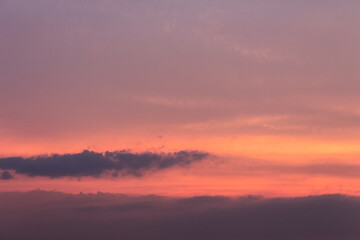 Wall Mural - glowing clouds on the red sky in evening light. dramatic weather in summer at dusk