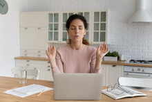 Young Hispanic Businesswoman Sit At Table In Kitchen Near Computer Closed Eyes Makes Breathing Technique Calming Exercises. Stress Management, Anxiety Relief Due Business Problem. Self-control Concept