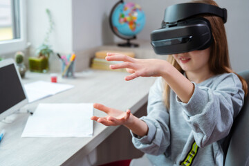 Wall Mural - schoolgirl is using virtual reality simulator headset for study. child is wearing virtual reality gl