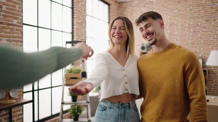 Wall Mural - Young couple smiling confident holding key of new house at new home