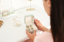 Woman With Jewelry Box On Table With Stylish Accessories