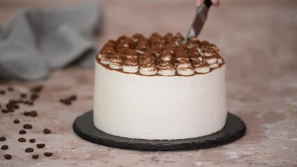 Wall Mural - Woman hands cutting delicious tiramisu cake.