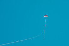 Low Angle View Of Kites Flying Against Clear Blue Sky