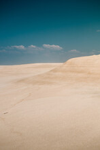 Sand Dunes At The Beach With White Sand And Blue Sky.