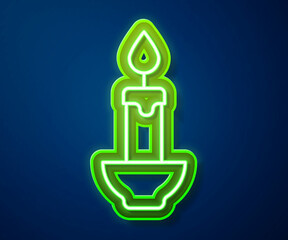 Sticker - Glowing neon line Burning candle icon isolated on blue background. Cylindrical candle stick with burning flame. Vector