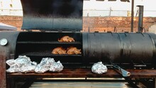 Turkey Carcasses Are Smoked In A Special Grill Smokehouse In The Form Of A Barrel, A Roll Of Foil For Packaging The Finished Dish And Sale