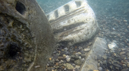 Wall Mural - Ruins of ancient column and construction blocks of antique city under water.