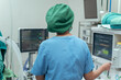 Anesthesiologist monitor the patient condition under general anesthesia during surgery in operation room.