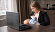 Young caucasian mother working remotely on laptop at home breastfeeding baby, caring and feeding newborn, happy motherhood