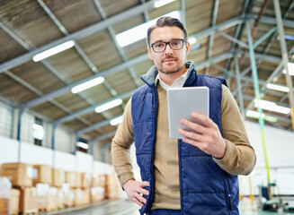 Poster - Tracking and tracing your order. Portrait of a man with a digital tablet working in a distribution warehouse.
