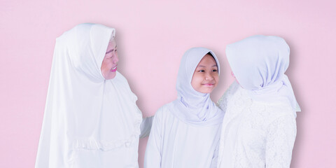 Wall Mural - Child with mother and grandmother at Eid mubarak