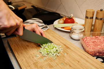 Woman cuts celery slices