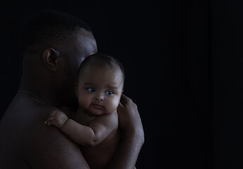 Black father holding a baby of newborn.African American Ethnicity people.