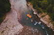 aerial view of mountain river people rafting in creek
