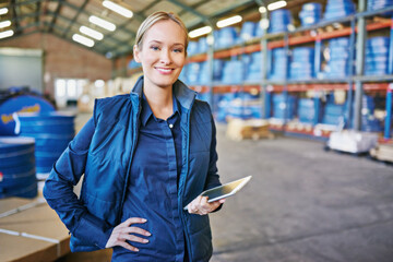 Poster - Tracking your order to its destination. Shot of a woman using a digital tablet in a large warehouse.