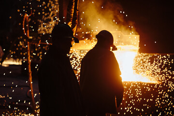 Wall Mural - Metallurgist steelmaker takes a sample of liquid metal from a ladle. Ingot casting. Steel production. Metallurgy. Industry