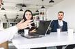 © xartproduction - Group of young business people working and communicating while sitting at the office desk together with colleagues sitting. business meeting