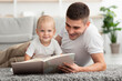 © Prostock-studio - Loving Father Reading Book For His Cute Infant Baby At Home