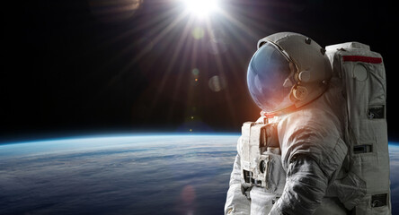Aufkleber - Astronaut in space. Spaceman on black background near Earth planet surface. Sci-fi wallpaper. Elements of this image furnished by NASA
