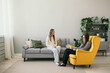 © Яна Айбазова - a female patient sits on a gray sofa and tells a psychologist to a woman about her problem. Psychological assistance to people