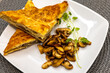 Simple breakfast, toast, puff pastry with fried mushrooms on a white plate