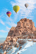 © muratart - Hot air balloon flying over spectacular Cappadocia, Uchisar castle in the background - Goreme, Turkey