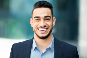 Closeup portrait of happy middle-eastern young businessman