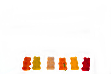 Sticker - Children, child are happy in front of colorful sweet wine gummy bears, white background, copy space