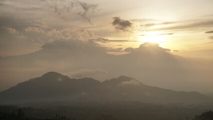 Wall Mural - sunrise over the mountains in cloudy weather. This is taken from Famous spot to see sunrise named Mangli Sky View. The place is named 