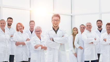 confident scientific leader standing in front of a team of young scientists.