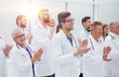 © ASDF - large group of medical practitioners applauding together.
