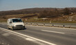 © Bojan - White modern delivery small shipment cargo courier van moving fast on motorway road to city urban suburb. Distribution and logistics express service. Mini bus driving on highway day. banner