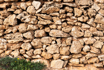 Brown nature stone wall of a local farmland