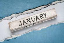 January Text On Grunge Wooden Block Against Handmade Rag Paper In Blue Tones, Calendar Concept